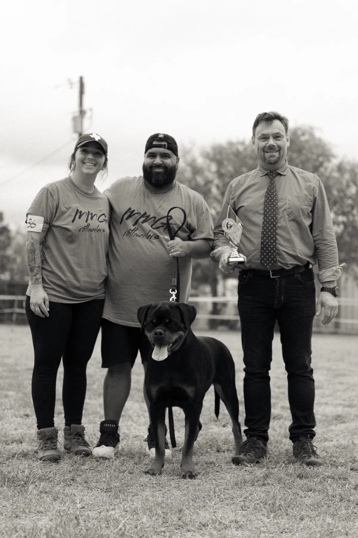 MMG Rottweilers team celebrating with trophy at dog show